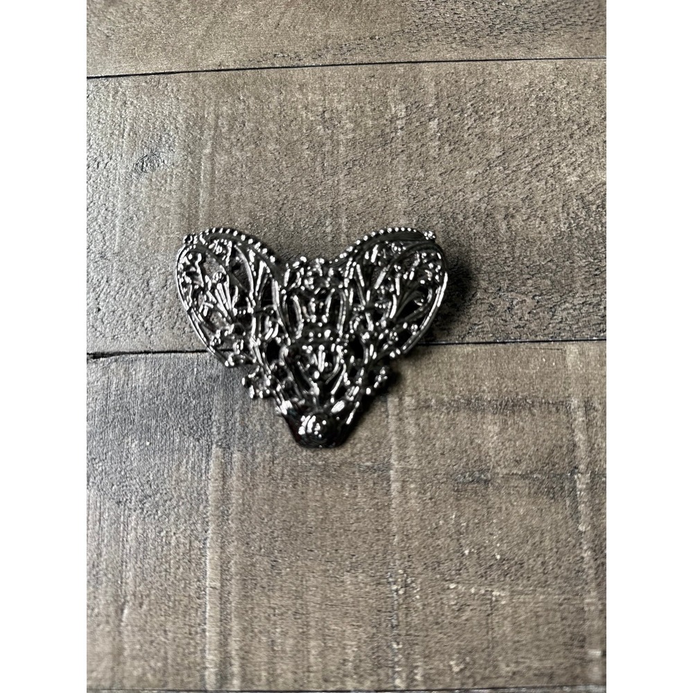 antique-style silver-tone metal filigree stamping brooch